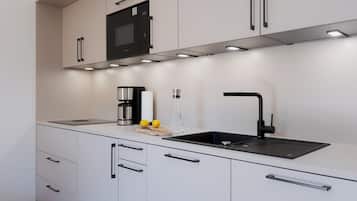 Fridge, stovetop, dishwasher, coffee/tea maker