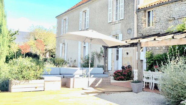 A two-story house with a covered patio, outdoor seating, and a garden area. - Stylish Manor House, 6 Bed, Heated Outdoor Pool, Outdoor Kitchen, Sleeps 15 (Pouille)
