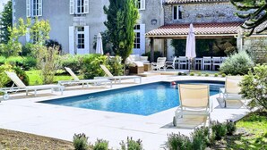 A house with a swimming pool, outdoor furniture, and a garden. - Stylish Manor House, 6 Bed, Heated Outdoor Pool, Outdoor Kitchen, Sleeps 15 (Pouille)