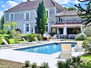A house with a swimming pool, outdoor furniture, and a garden. - Stylish Manor House, 6 Bed, Heated Outdoor Pool, Outdoor Kitchen, Sleeps 15 (Pouille)
