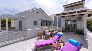 A rooftop terrace with lounge chairs, a table, and a pergola. - Alisahni Villa, Villa (Chania)