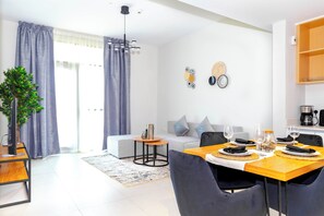 Relax in this stylish living space with a dining area, comfortable sofa, and potted plant.