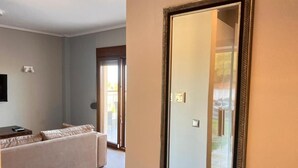 A living room with a beige sofa, a flat-screen TV, and a sliding glass door leading to a balcony. - VILLA BORA-BORA (Kassandra)