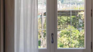 Comfort Triple Room, Garden View | In-room safe, blackout curtains, soundproofing, iron/ironing board