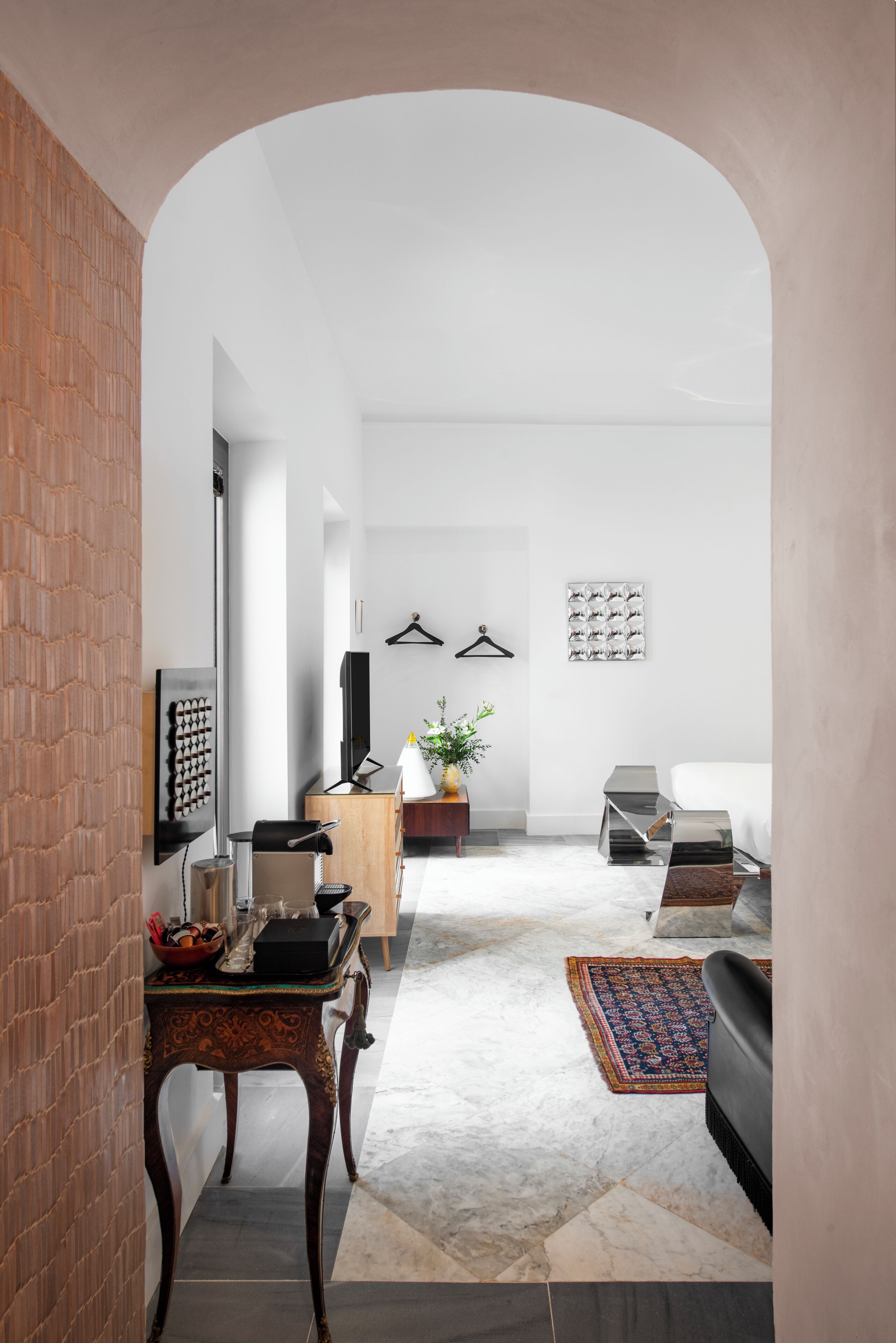 A modern living room with a fireplace, a coffee table, and a sofa.