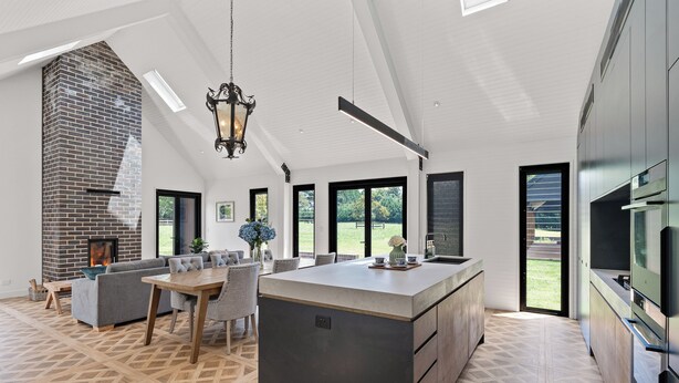 A modern kitchen with a large island, built-in appliances, and a fireplace. - The Mist, Luxury Farm Retreat w/ Fireplace & Hot tub | Southern Highlands (Exeter)