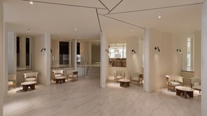 A spacious hotel lobby with a modern design, featuring a marble floor, multiple seating areas, and a staircase leading to upper floors. - Orient Luxury Hotel-KenTing (Hengchun)