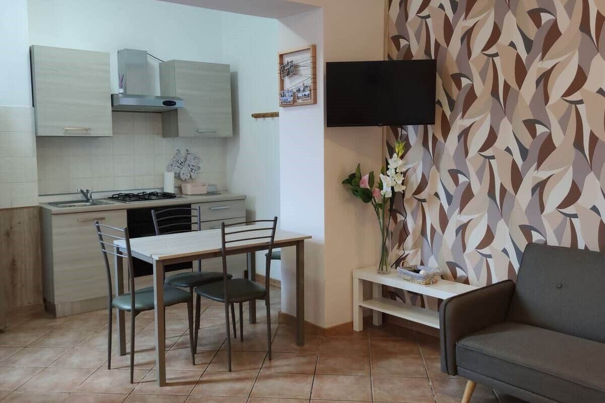 A compact living space with a dining area, kitchen, and seating area.