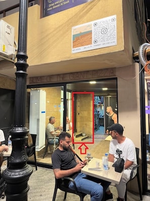 A restaurant with a sign reading 'HOME OF THE GIANT PIZZA' and a QR code for contact. - Timberwood Studio in Batroun (Batroun)