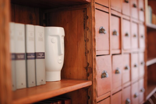 A wooden shelf with a white object and a row of closed drawers. - (New) Ponte Vecchio Tower (Firenze)