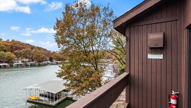 A wooden building with a fire extinguisher mounted on the wall. - Lakefront Condo Indoor pool, sauna, & pickle ball! (Osage Beach)
