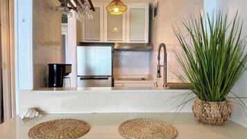 Fridge, microwave, coffee/tea maker, cookware/dishes/utensils