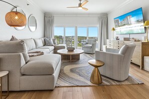 A modern living room with a sofa, armchairs, a coffee table, and a TV. - 2 Bedroom Beach Manor condo on the 6th Floor at Tops’l Resort with Sandestin Resort Perks!! (Miramar Beach)