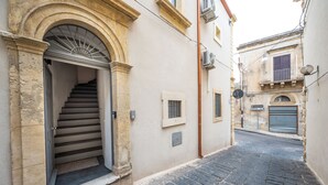 A narrow cobblestone street with a staircase leading to a building entrance. - Demetra - One Bedroom Apartment, Sleeps 4 (Noto)