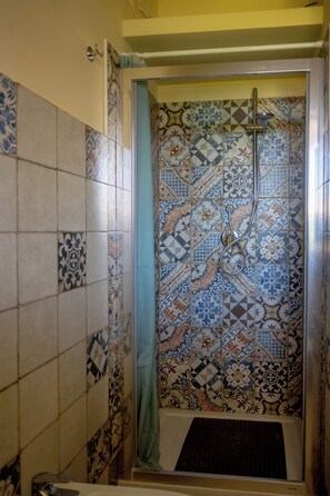 A shower with a tiled wall and a showerhead. - Villa Zuzana - Two Bedroom Apartment, Sleeps 4 (Calabernardo)