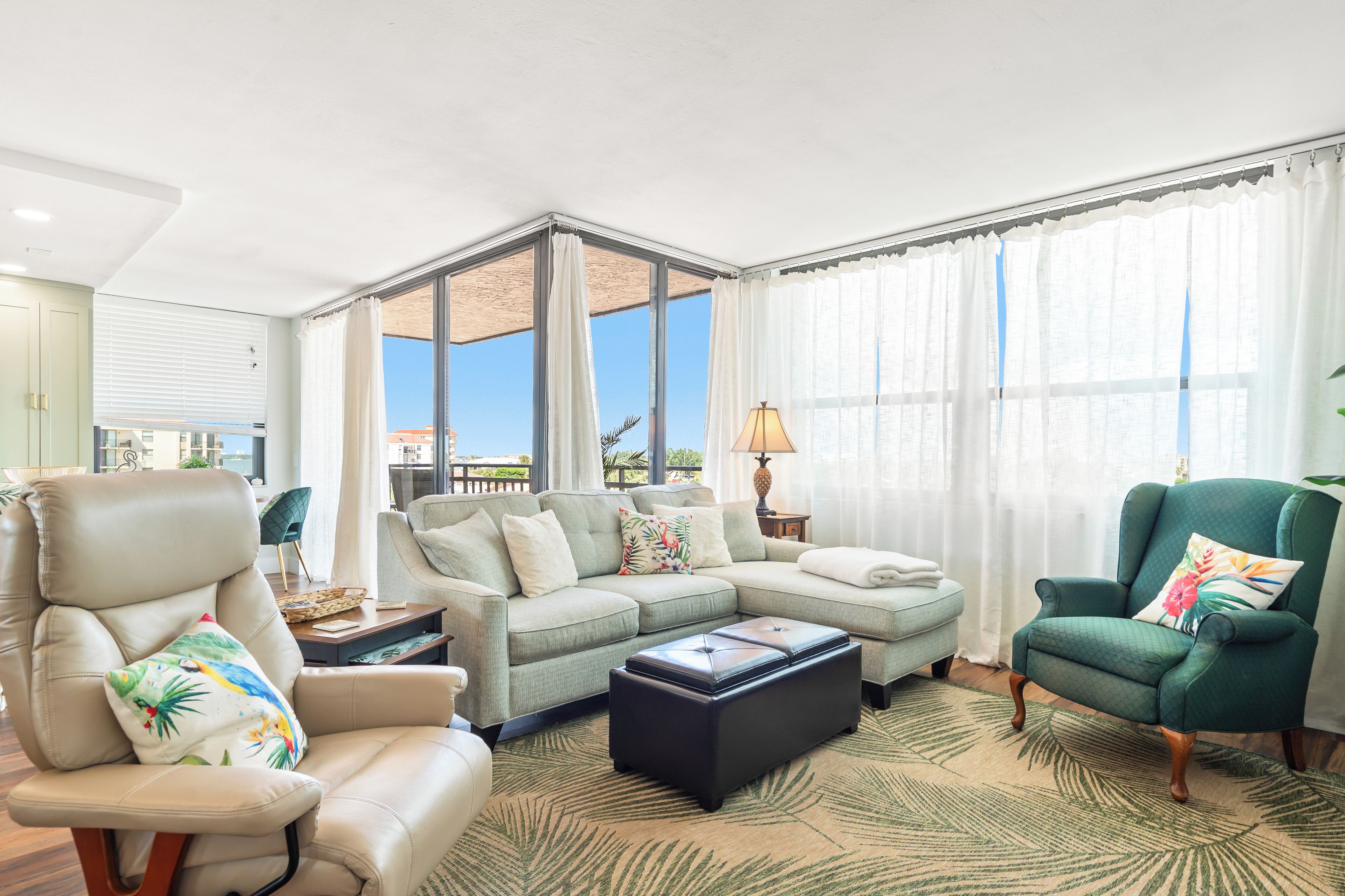 A spacious living room with a large sectional sofa, a chaise lounge, and a coffee table.