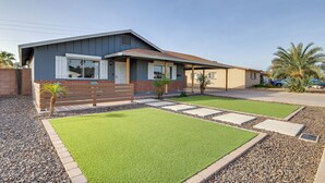 A modern house with a well-maintained lawn, a wooden deck, and a driveway. - Families w/ Pets Welcome! Home 4 Mi to Dtwn Tempe (Tempe)