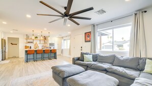 A spacious living area with a gray sectional sofa, ottomans, and a ceiling fan. - Families w/ Pets Welcome! Home 4 Mi to Dtwn Tempe (Tempe)
