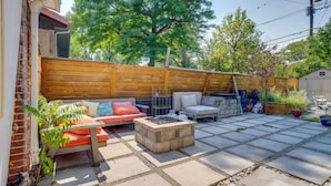 A patio with a fire pit, outdoor furniture, and a wooden fence. - 10 Mi to Red Rocks: Denver Home w/ Fire Pit! (Denver)