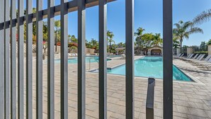 A pool area with multiple pools, lounge chairs, and palm trees. - Private & Spacious Deluxe Rolling Hills Ranch Gem (Chula Vista)