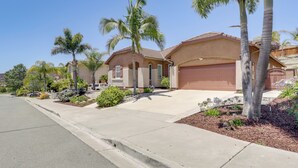 A residential house with a garage, palm trees, and a well-maintained driveway. - Private & Spacious Deluxe Rolling Hills Ranch Gem (Chula Vista)