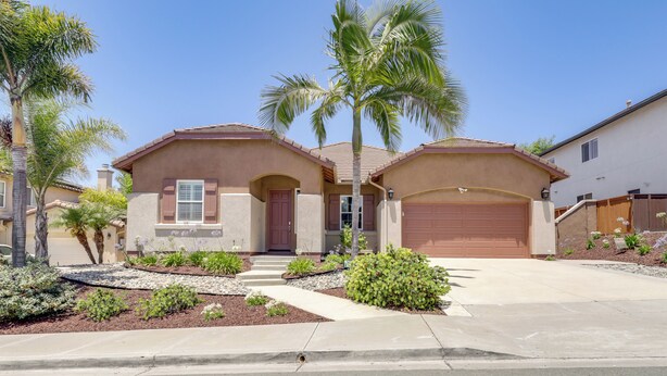 A two-story house with a garage, palm trees, and a well-maintained garden. - Private & Spacious Deluxe Rolling Hills Ranch Gem (Chula Vista)