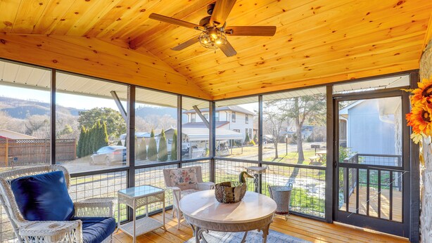 A covered patio with wicker furniture, a ceiling fan, and large windows offering a view of the backyard. - 2 Blocks to Appalachian Trail! Couple's Retreat (Hot Springs)