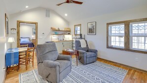A spacious living room with a high ceiling fan, a dining area with a table and chairs, and a kitchen in the background. - Walk to Appalachian Trail: Hot Springs Hideaway (Hot Springs)