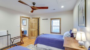 A bedroom with two beds, a wooden ceiling fan, a window, and a door. - Walk to Appalachian Trail: Hot Springs Hideaway (Hot Springs)