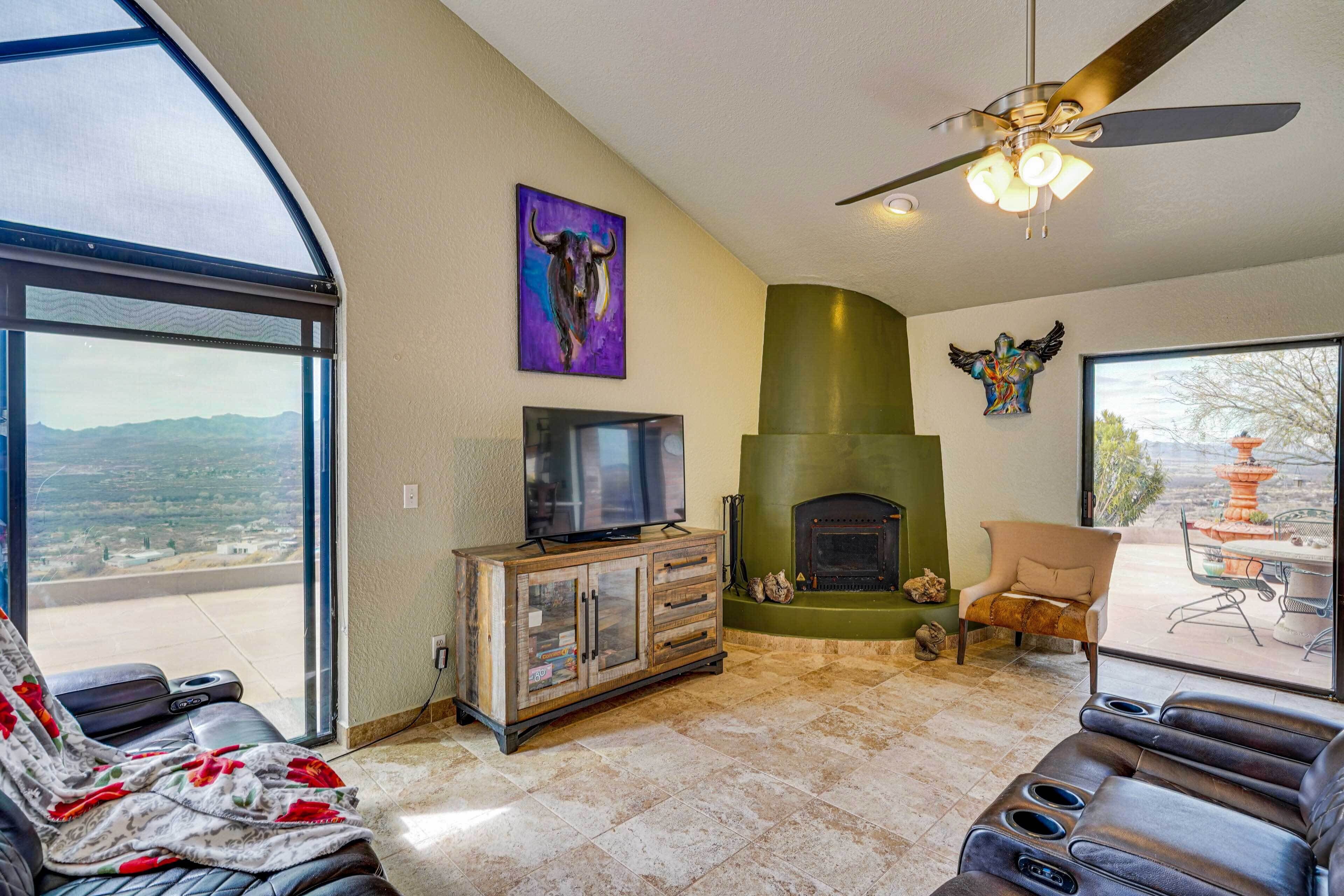 A spacious living room with a fireplace, a large TV, and a comfortable seating area.