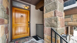 A wooden front door with a metal mail slot and a doormat. - 3 Miles to Resort | Hot Tub | Fireplace | EV Charger | Great for Groups (Winter Park)