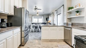 A modern kitchen with white cabinetry, stainless steel appliances, and a granite countertop. - 4 Mi to Lake Powell: Retreat w/ Game Room! (Page)