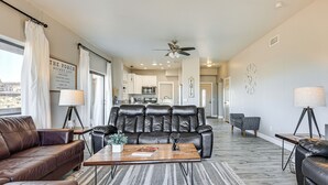 A modern living room with a leather sofa, a coffee table, and a dining area in the background. - 4 Mi to Lake Powell: Retreat w/ Game Room! (Page)