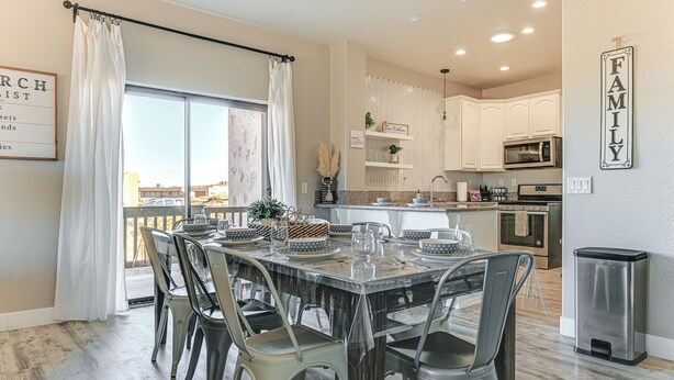 A dining area with a table set for six, surrounded by chairs, in a modern kitchen with white cabinets and stainless steel appliances. - 4 Mi to Lake Powell: Retreat w/ Game Room! (Page)