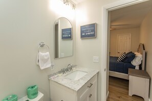 A bathroom with a white sink, a mirror, and two motivational signs. - Royal Garden Resort 601 3 Bedroom Condo (Murrells Inlet)