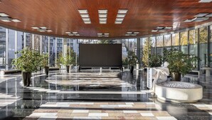 A spacious lobby with a polished floor, large windows, and a central seating area with a statue. - Kristal 2,5 bed Lux Apartment in Rogaška (Šmarje pri Jelšah)