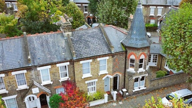 A residential building with a pitched roof, multiple windows, and a small turret-like structure. - Battersea Bright House | Sleeps 4 (London)