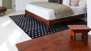 A bedroom with a bed, bedside table, and a hanging light fixture. - This Maine House-Near Ocean! (Tremont)