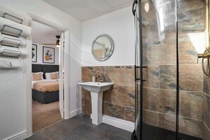 Shower, hair dryer, towels, shampoo