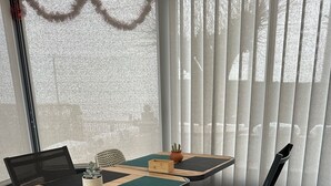 A dining area with a table, chairs, and a potted plant.