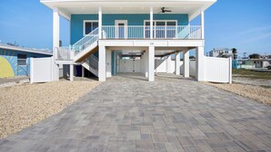 A two-story building with a covered walkway and a balcony. - ☀️ Private Pool - Short Walk to Beach - Betty's Beach House ☀️ (Fort Myers Beach)