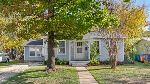 A two-story house with a front yard, a driveway, and a mailbox. - 3BR in Crestview • 2 Kings • UT • Downtown • Events • Free Parking (Austin)