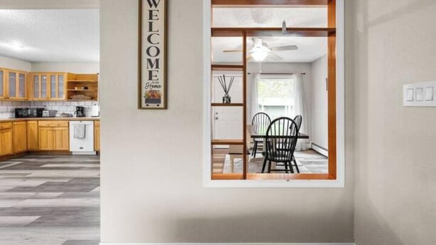 A modern kitchen with wooden cabinets and a grey floor. - Midnight Sun Viewpoint Aurora (Fairbanks)