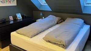 A bedroom with a bed, a desk, and a skylight. - Family house in Mosfellsbær (Mosfellsbær)