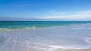 A beach with clear blue water and a sandy shore. - 2/2 Bay Front Condo, Pool, Private Beach Access (Longboat Key)