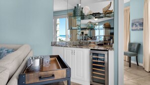 A compact kitchen with a glass backsplash, white cabinetry, and a view of the beach. - Drastic Reduction for Labor Day! Gulf front, updated, Pool, Hot Tub plus Gym. (Destin)