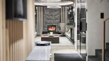 A modern living room with a fireplace, a sofa, and a coffee table.