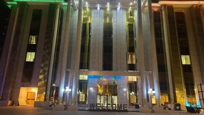 A large, modern building with a prominent entrance and illuminated welcome sign. - Golden Vista Hotels (Owerri)
