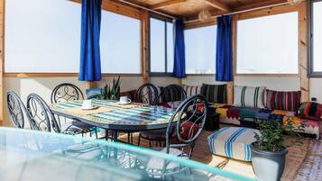 Enjoy a romantic dinner for two in this charming outdoor dining area, complete with a round table and comfortable seating.