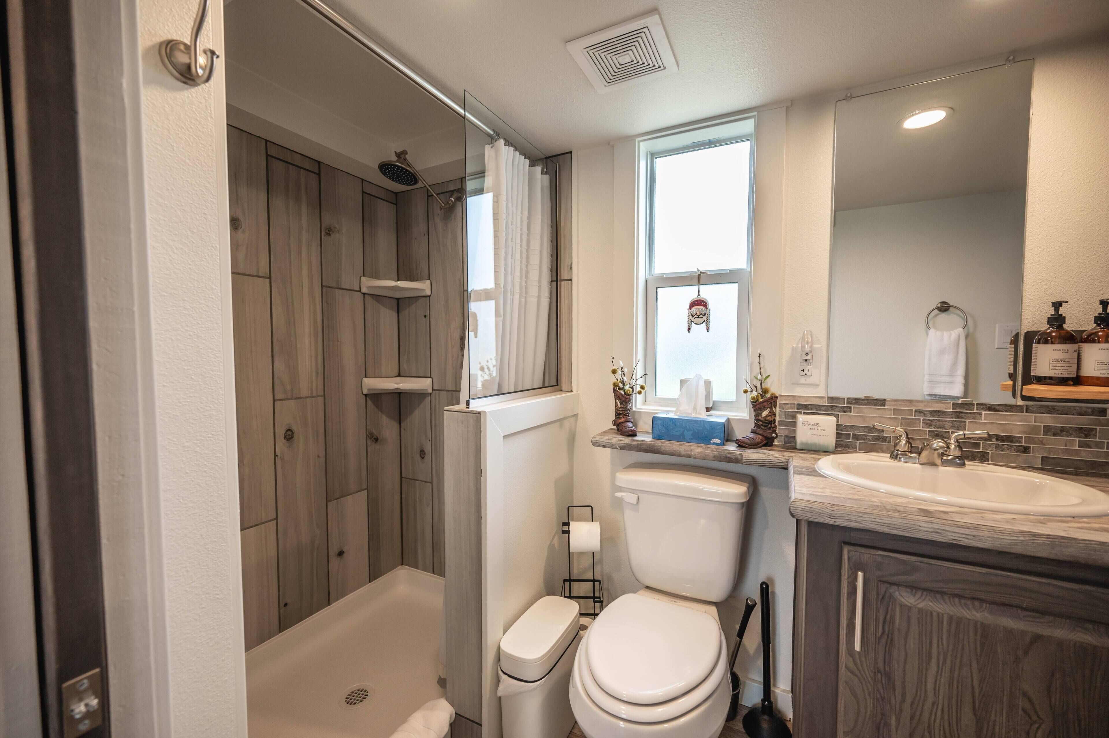 Ein modernes Badezimmer mit Dusche, Toilette und Waschbecken.